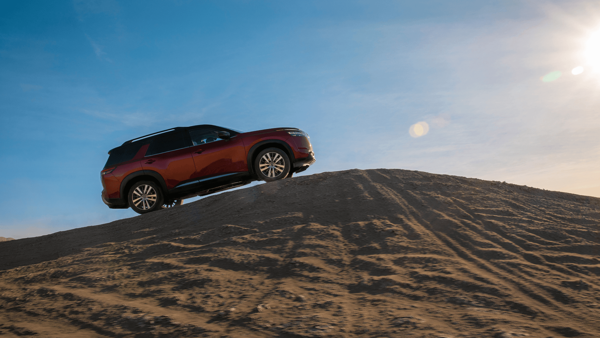 2025 Nissan Pathfinder climbing a mountain of sand